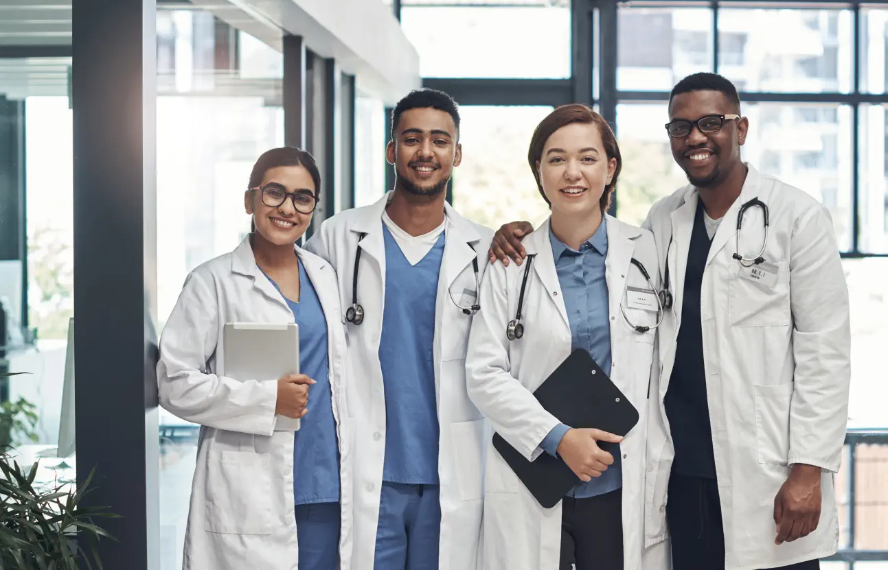four doctors smiling