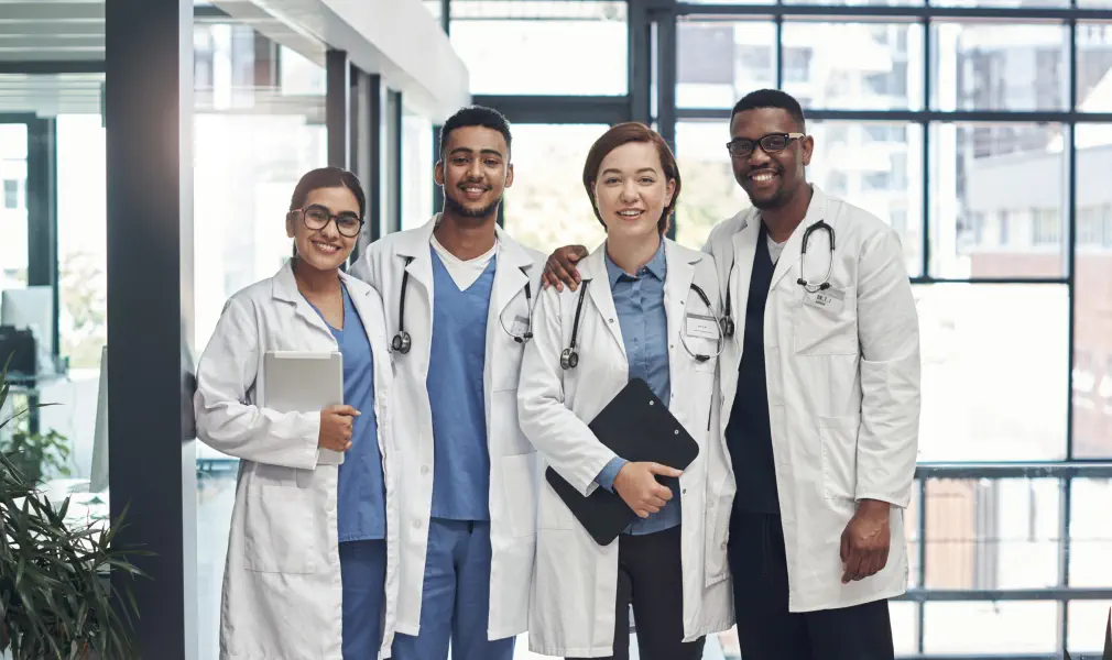 four doctors smiling