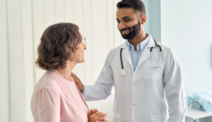 male doctor comforting elderly woman