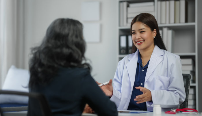female doctor consulting elderly woman