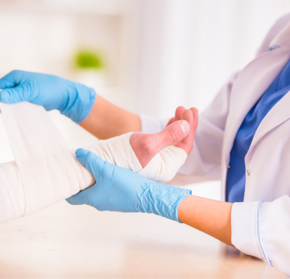 doctor bandaging an injured hands