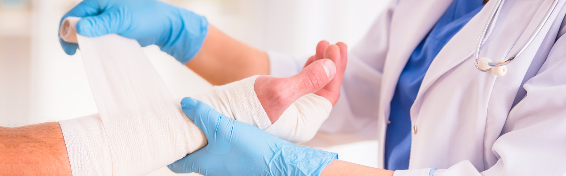 doctor bandaging an injured hands