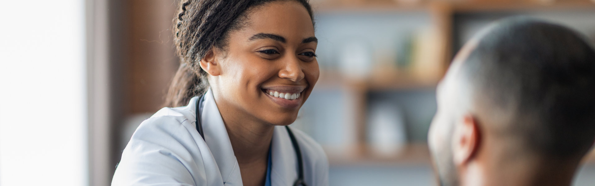 doctor touching patient shoulder